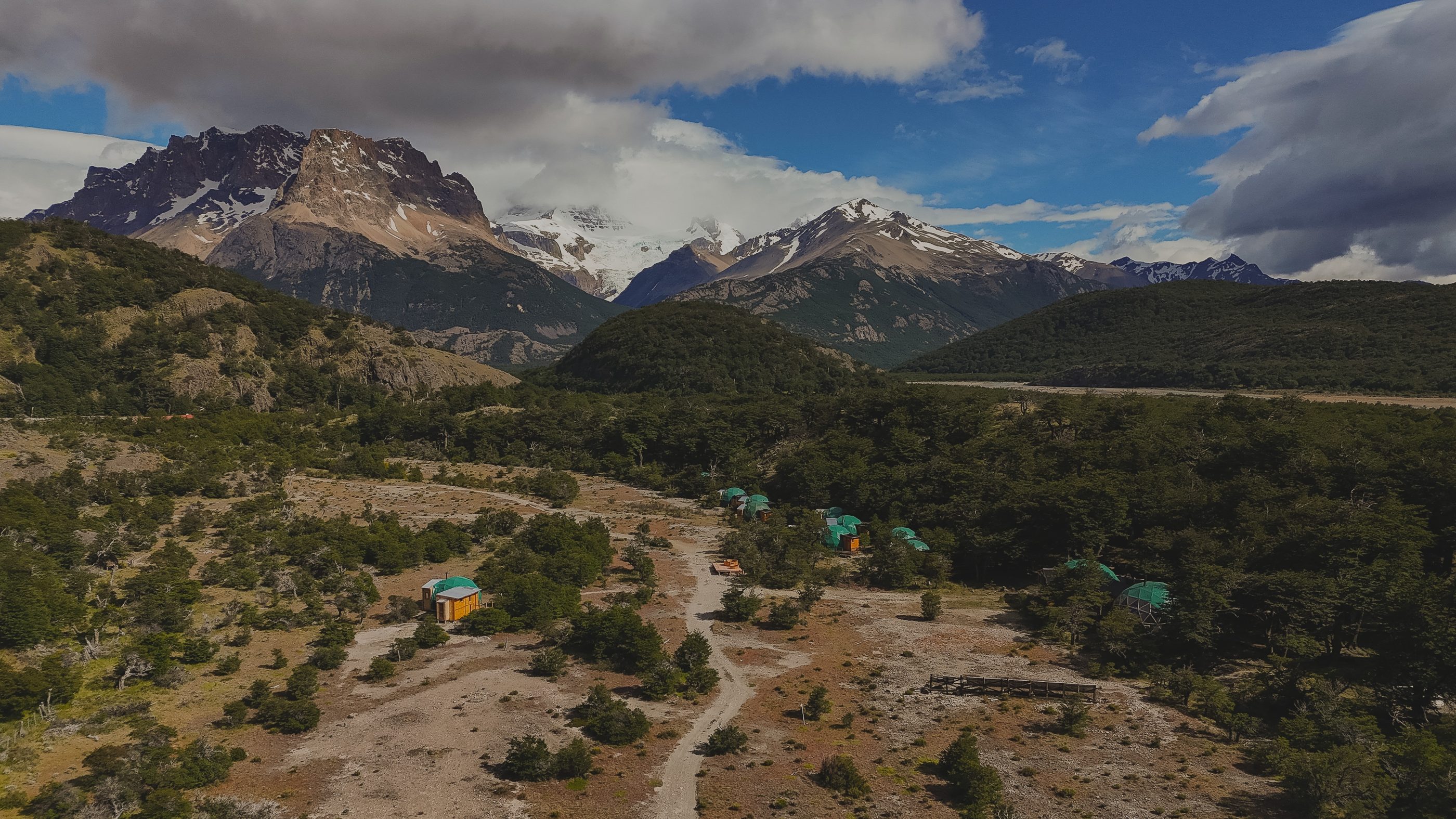 The Eco Domes camp among the lenga trees, with the mountains behind, El Chaltén