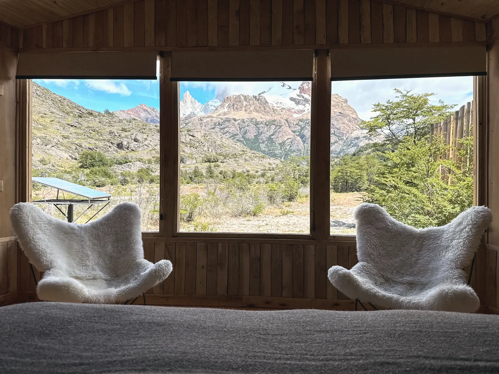 Two sheepskin armchairs at the dome window